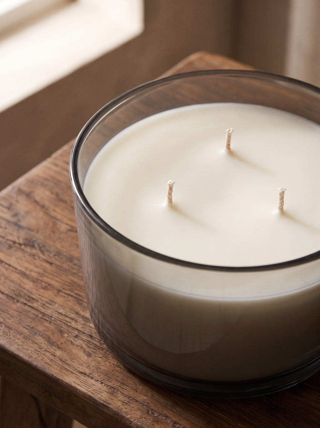 Close-up of the three cotton wicks in the off-white wax of the Cedar & Vetiver candle