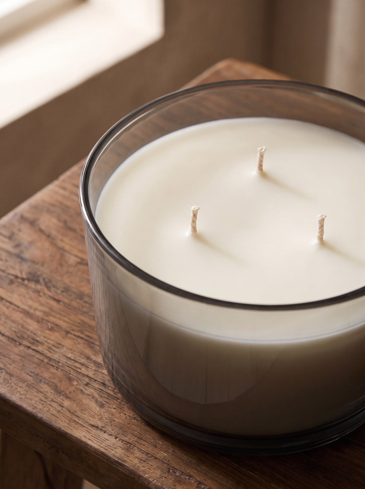Close-up of the three cotton wicks in the off-white wax of the Cedar & Vetiver candle