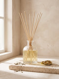 White Tea & Bergamot reed diffuser in a clear ribbed glass bottle with rattan reeds